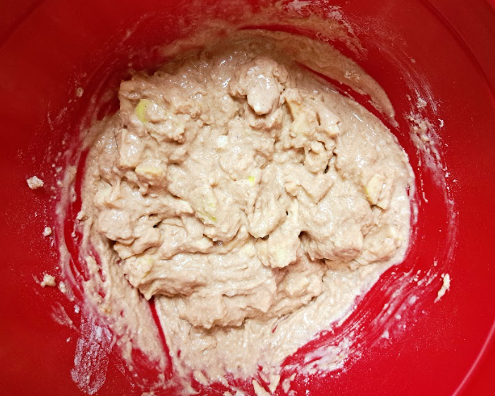 a close up of apple spice loaf batter mixed in a red bowl